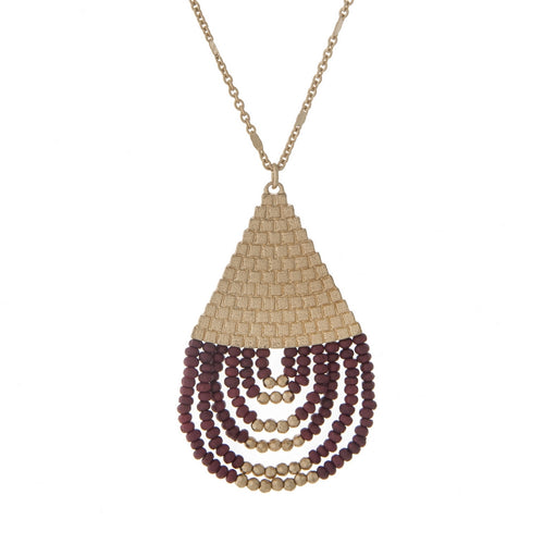 Gold necklace with burgundy teardrop pendant