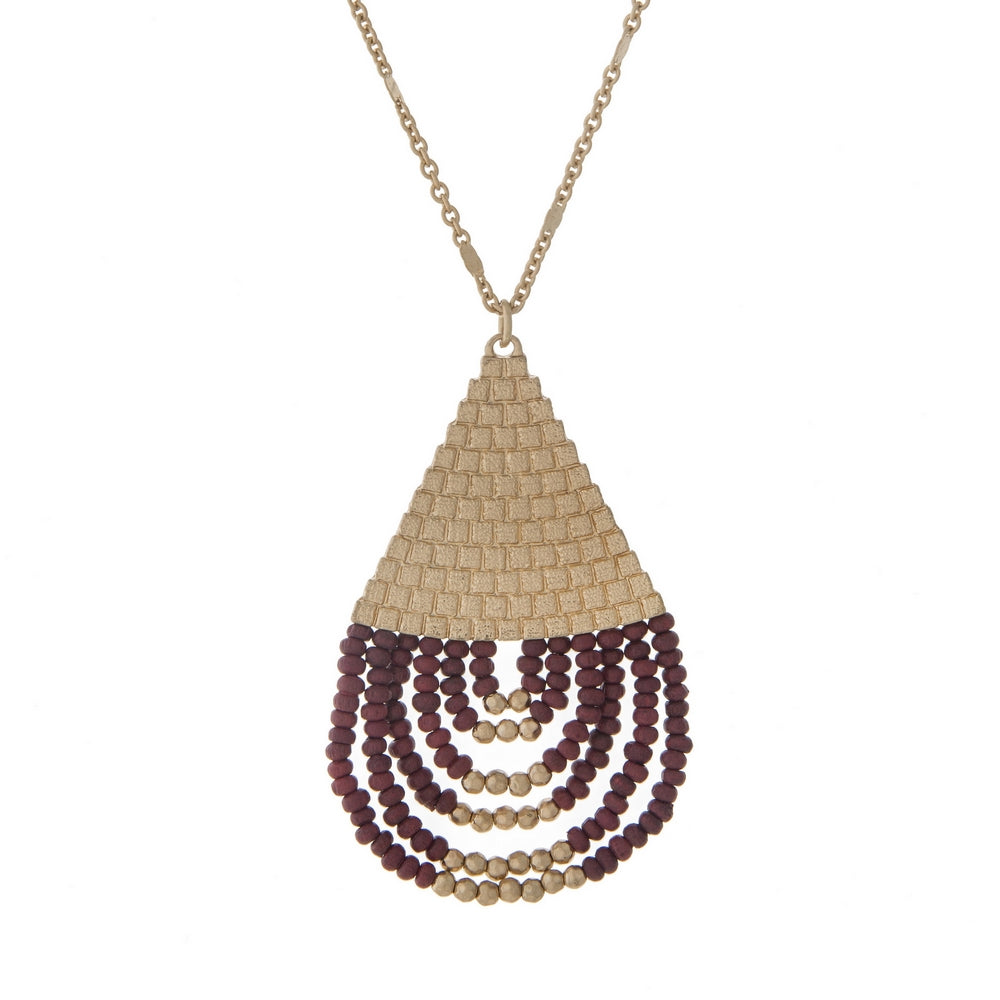 Gold necklace with burgundy teardrop pendant